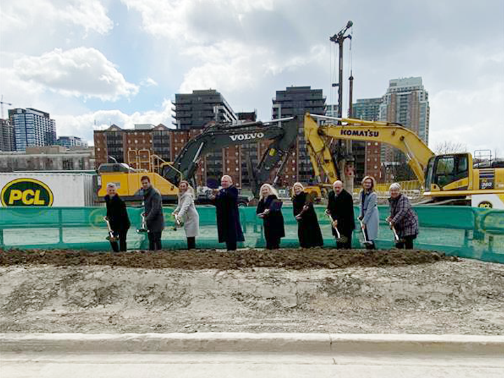Nine people shavel in the ground of CAMH Phase 1D construction site